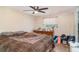 Bedroom with dresser, window, and patterned bedspread at 3921 Marlborough Pl, Sarasota, FL 34241