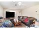 Cozy living room features large TV, ceiling fan and comfortable seating at 3921 Marlborough Pl, Sarasota, FL 34241