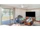 Living room with ceiling fan, view of the lake, and comfortable seating at 3921 Marlborough Pl, Sarasota, FL 34241