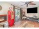 The living room features a vintage gas pump, fireplace and sliding glass doors at 3921 Marlborough Pl, Sarasota, FL 34241
