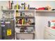 Storage room featuring shelving, hot water heater, and washer and dryer at 3921 Marlborough Pl, Sarasota, FL 34241
