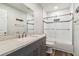 Modern bathroom featuring a vanity, updated fixtures, and shower with glass door at 4061 Crockers Lake Blvd # 27, Sarasota, FL 34238