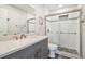 Modern bathroom features a gray vanity, quartz countertop, stylish tile shower, and sleek fixtures at 4061 Crockers Lake Blvd # 27, Sarasota, FL 34238
