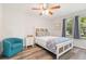 Bright bedroom with a decorative bed, a cozy chair, and a large window that lets in natural light at 4061 Crockers Lake Blvd # 27, Sarasota, FL 34238