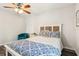 Inviting bedroom featuring a queen bed with blue and white bedding, and a comfortable blue chair at 4061 Crockers Lake Blvd # 27, Sarasota, FL 34238