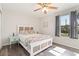 A serene bedroom featuring natural light, wooden floors, ceiling fan, and nice decorations at 4061 Crockers Lake Blvd # 27, Sarasota, FL 34238