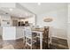 Cozy dining area features a wood table, modern chairs, and stylish decor, next to the updated kitchen at 4061 Crockers Lake Blvd # 27, Sarasota, FL 34238