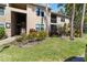 Attractive condo building showcasing covered entries and surrounding lush landscaping with palm trees at 4061 Crockers Lake Blvd # 27, Sarasota, FL 34238