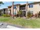 Charming exterior view showcasing lush landscaping, mature palm trees, and condo design at 4061 Crockers Lake Blvd # 27, Sarasota, FL 34238