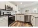 Bright kitchen with white cabinets, stainless steel appliances, granite countertop and wood-look floors at 4061 Crockers Lake Blvd # 27, Sarasota, FL 34238