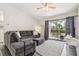 Cozy living room with comfy sofa, ceiling fan, and sliding glass doors to the balcony at 4061 Crockers Lake Blvd # 27, Sarasota, FL 34238