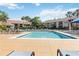 A community pool with lounge chairs and a residential building behind it on a sunny day at 4061 Crockers Lake Blvd # 27, Sarasota, FL 34238