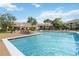 Large community pool with lounge chairs and well-maintained landscaping around the residential buildings at 4061 Crockers Lake Blvd # 27, Sarasota, FL 34238