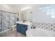 Bathroom with double sinks, white tile walls, garden tub, and enclosed shower with decorative seashell shower curtain at 4307 Manfield Dr, Venice, FL 34293