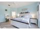Comfortable bedroom with wood-look floors, a ceiling fan, desk/vanity, and a white wooden bed frame at 4307 Manfield Dr, Venice, FL 34293