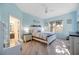 Comfortable bedroom with wood-look floors, a ceiling fan, and a window with natural light at 4307 Manfield Dr, Venice, FL 34293