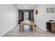 Modern dining room with a long wood table, bench seating, and natural light at 4307 Manfield Dr, Venice, FL 34293