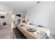 Bright dining area with wood-look table, bench seating, and elegant table setting at 4307 Manfield Dr, Venice, FL 34293
