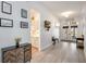 Bright foyer featuring wood-look floors, elegant lighting, and views into the kitchen at 4307 Manfield Dr, Venice, FL 34293