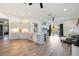 Open floor plan featuring the kitchen with center island and open to the living room with sliding doors to the patio at 4307 Manfield Dr, Venice, FL 34293