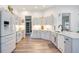 Bright kitchen features white cabinets and appliances, lots of counter space, and modern decor at 4307 Manfield Dr, Venice, FL 34293