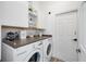 Laundry room features front load washer and dryer with counter space and white cabinets for storage at 4307 Manfield Dr, Venice, FL 34293