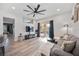 Bright living room featuring wood-look floors, a ceiling fan, and a sliding glass door with backyard view at 4307 Manfield Dr, Venice, FL 34293