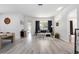 Spacious living room with wood-look floors, neutral walls, and large windows for natural light at 4307 Manfield Dr, Venice, FL 34293