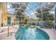 Refreshing screened-in pool with lounge chairs, lush landscaping, and ample space for entertaining at 4307 Manfield Dr, Venice, FL 34293