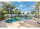 Inviting screened-in pool surrounded by mature greenery and a secure fence for privacy at 4307 Manfield Dr, Venice, FL 34293