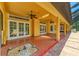 Large covered back patio with brick pavers, ceiling fans, and backyard access at 4647 Stone Ridge Trl, Sarasota, FL 34232