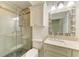 Modern bathroom featuring a glass shower, granite vanity and decorative mirror at 4647 Stone Ridge Trl, Sarasota, FL 34232