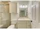 Updated bathroom with tiled shower, granite vanity and decorative mirror frame at 4647 Stone Ridge Trl, Sarasota, FL 34232