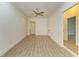 Spacious empty bedroom features modern flooring, trim and a ceiling fan at 4647 Stone Ridge Trl, Sarasota, FL 34232