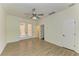 Spacious empty bedroom features modern flooring, trim, ceiling fan, and access to the outside at 4647 Stone Ridge Trl, Sarasota, FL 34232