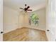 Spacious bedroom with an arched window offering a pleasant view, and a ceiling fan at 4647 Stone Ridge Trl, Sarasota, FL 34232