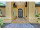 Elegant double front doors with stone steps, pillars, and lush landscaping at 4647 Stone Ridge Trl, Sarasota, FL 34232