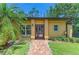 Inviting home exterior featuring a brick path, well-maintained lawn, and mature landscaping at 4647 Stone Ridge Trl, Sarasota, FL 34232