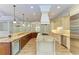 Modern kitchen featuring an island, stainless steel appliances, and custom cabinets at 4647 Stone Ridge Trl, Sarasota, FL 34232