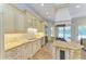 Gourmet kitchen features stainless steel appliances, granite countertops, and custom cabinetry at 4647 Stone Ridge Trl, Sarasota, FL 34232