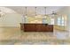 Gourmet kitchen features large island, pendant lights and stainless steel appliances at 4647 Stone Ridge Trl, Sarasota, FL 34232