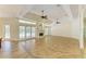 Open concept living room with a fireplace, tile floors, and large windows at 4647 Stone Ridge Trl, Sarasota, FL 34232