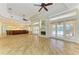 Open living area features a fireplace, wood floors, and access to the outdoor living at 4647 Stone Ridge Trl, Sarasota, FL 34232