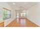 Bright living room featuring tile flooring, a ceiling fan, and ample natural light through the windows at 4647 Stone Ridge Trl, Sarasota, FL 34232