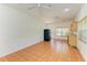 Open-concept living room with tile flooring, ceiling fans, and access to the backyard at 4647 Stone Ridge Trl, Sarasota, FL 34232