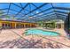 Aerial view of screened pool, paved patio, gazebo, and backyard at 4647 Stone Ridge Trl, Sarasota, FL 34232