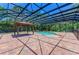 Beautiful in-ground pool surrounded by brick pavers and screened enclosure at 4647 Stone Ridge Trl, Sarasota, FL 34232