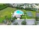 Overhead shot of the community pool, basketball court, and lush green space and parking at 4727 Sabal Key Dr # 4727, Bradenton, FL 34203