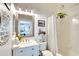 Bright bathroom with a new vanity, framed mirror, and shower with a decorative curtain at 4727 Sabal Key Dr # 4727, Bradenton, FL 34203