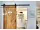 Bathroom with a rustic sliding barn door, toilet and vanity at 4727 Sabal Key Dr # 4727, Bradenton, FL 34203